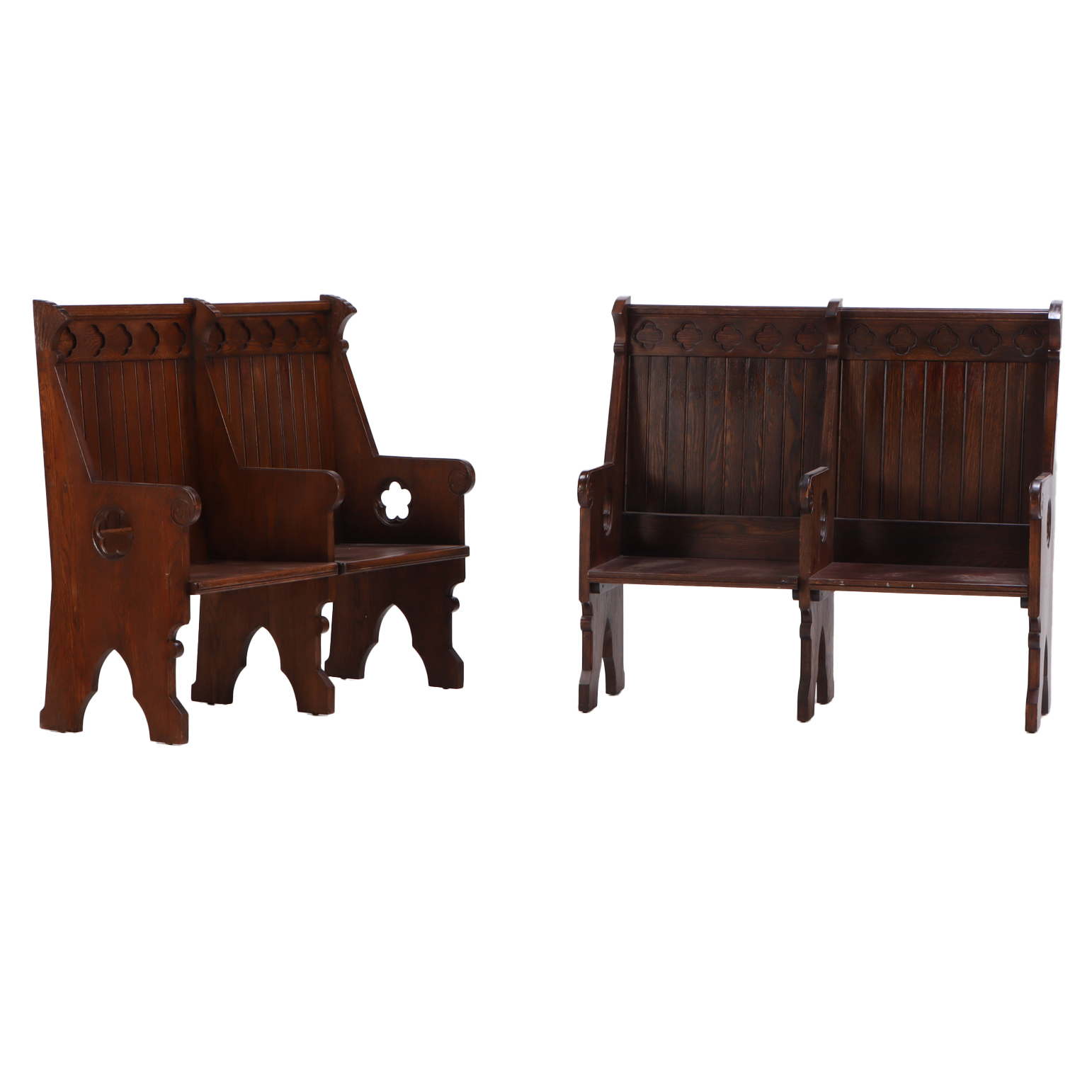 A pair of American Gothic style carved oak double benches, C. 1900.